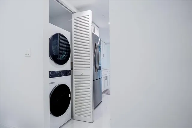 a view of a hallway with washer and dryer