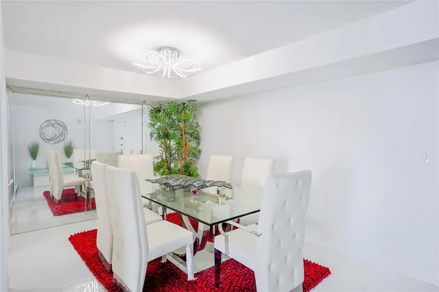 a view of a dining room with furniture and a chandelier