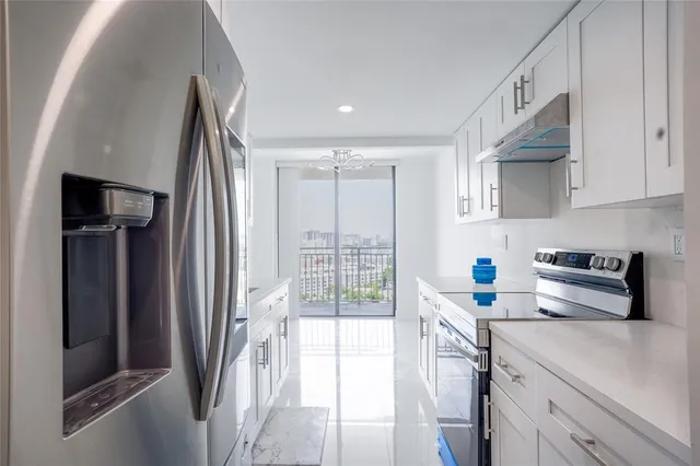a kitchen with stainless steel appliances a refrigerator and a sink