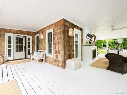 a view of a house with backyard and sitting area