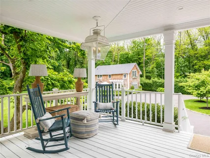 a view of a chair and tables front of the house