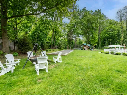 a view of a bench in the garden near a house