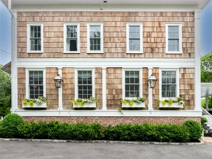 front view of a brick building with a yard