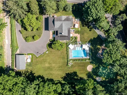 an aerial view of a house with a garden and yard