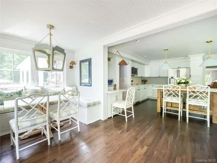 a view of a dining room with furniture window and wooden floor