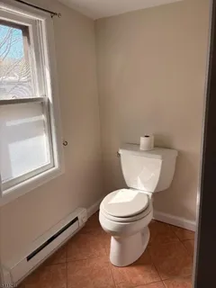 a white toilet sitting next to a window
