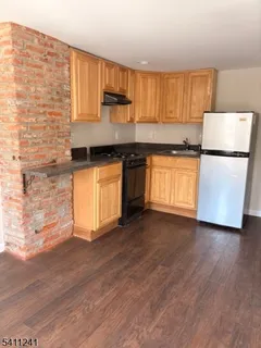 a kitchen with stainless steel appliances a refrigerator sink and cabinets