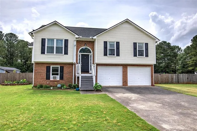 a front view of a house with a yard and garage