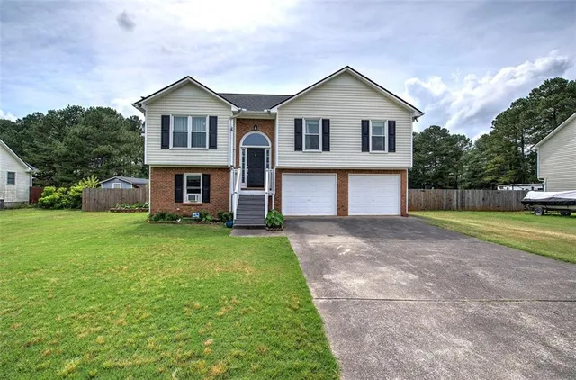 a front view of a house with a yard and garage