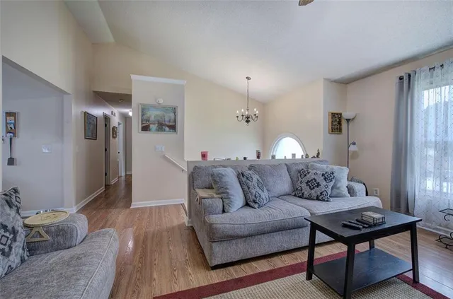 a living room with furniture and a chandelier