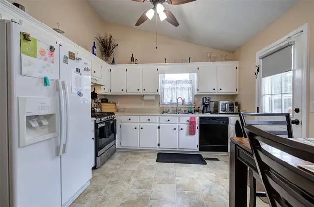 a kitchen with cabinets and stainless steel appliances