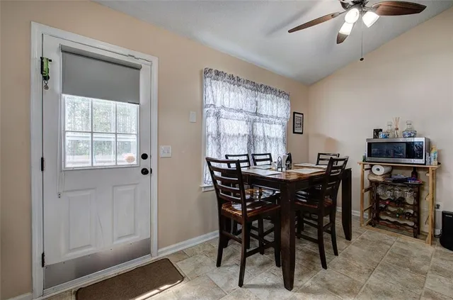 a view of a dining room with furniture and chandelier