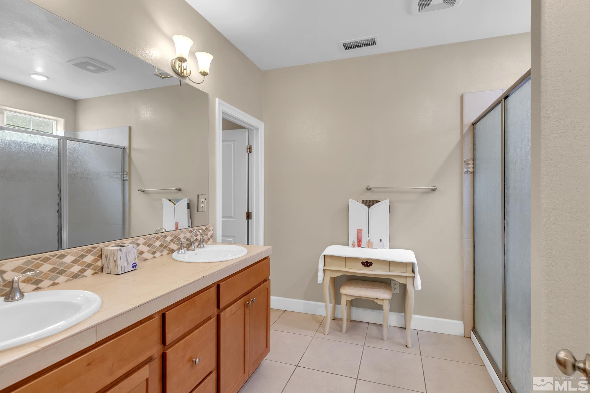 1880 Dark Horse Road, Unit A Reno, NV 89521 - Photo 11 of 20 a bathroom with a sink double vanity and a mirror