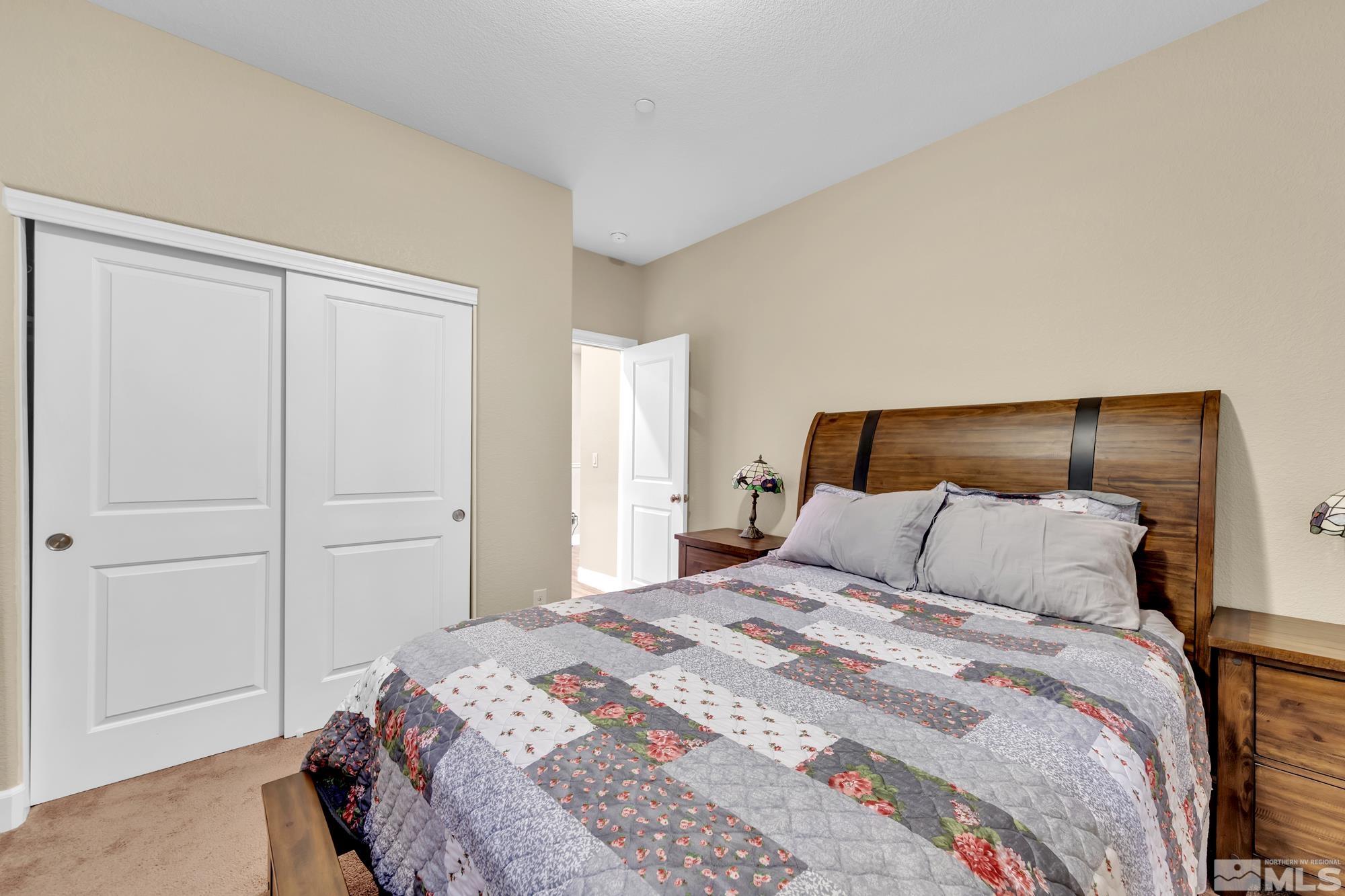 1880 Dark Horse Road, Unit A Reno, NV 89521 - Photo 12 of 20 a bedroom with a bed and a mirror