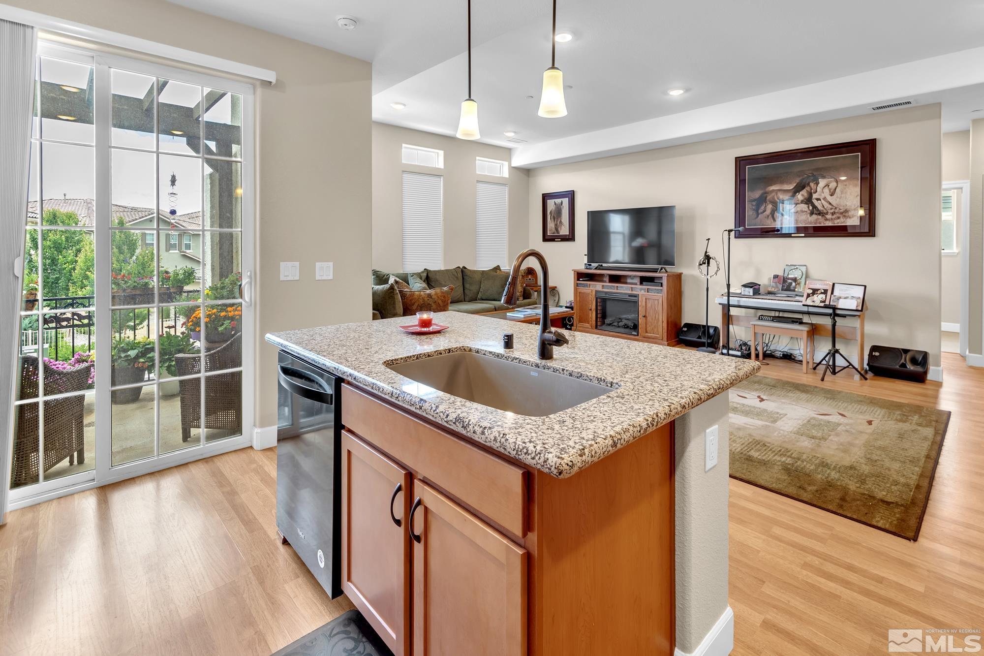 1880 Dark Horse Road, Unit A Reno, NV 89521 - Photo 7 of 20 a kitchen with stainless steel appliances granite countertop a sink stove and wooden floor