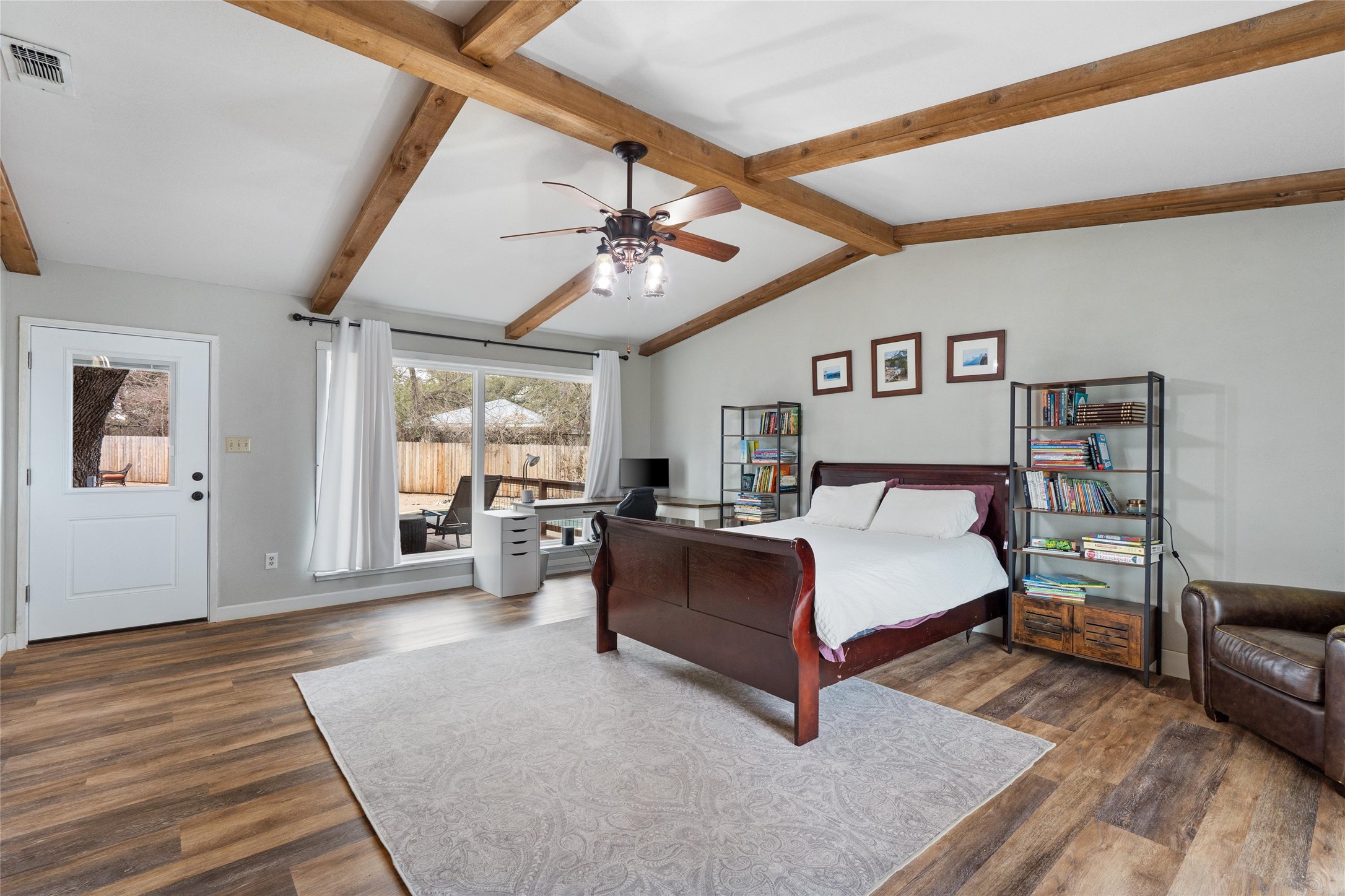 720 Circle G Ranch Road Austin, TX 78737 - Photo 16 of 37 a spacious bedroom with a bed and wooden floor