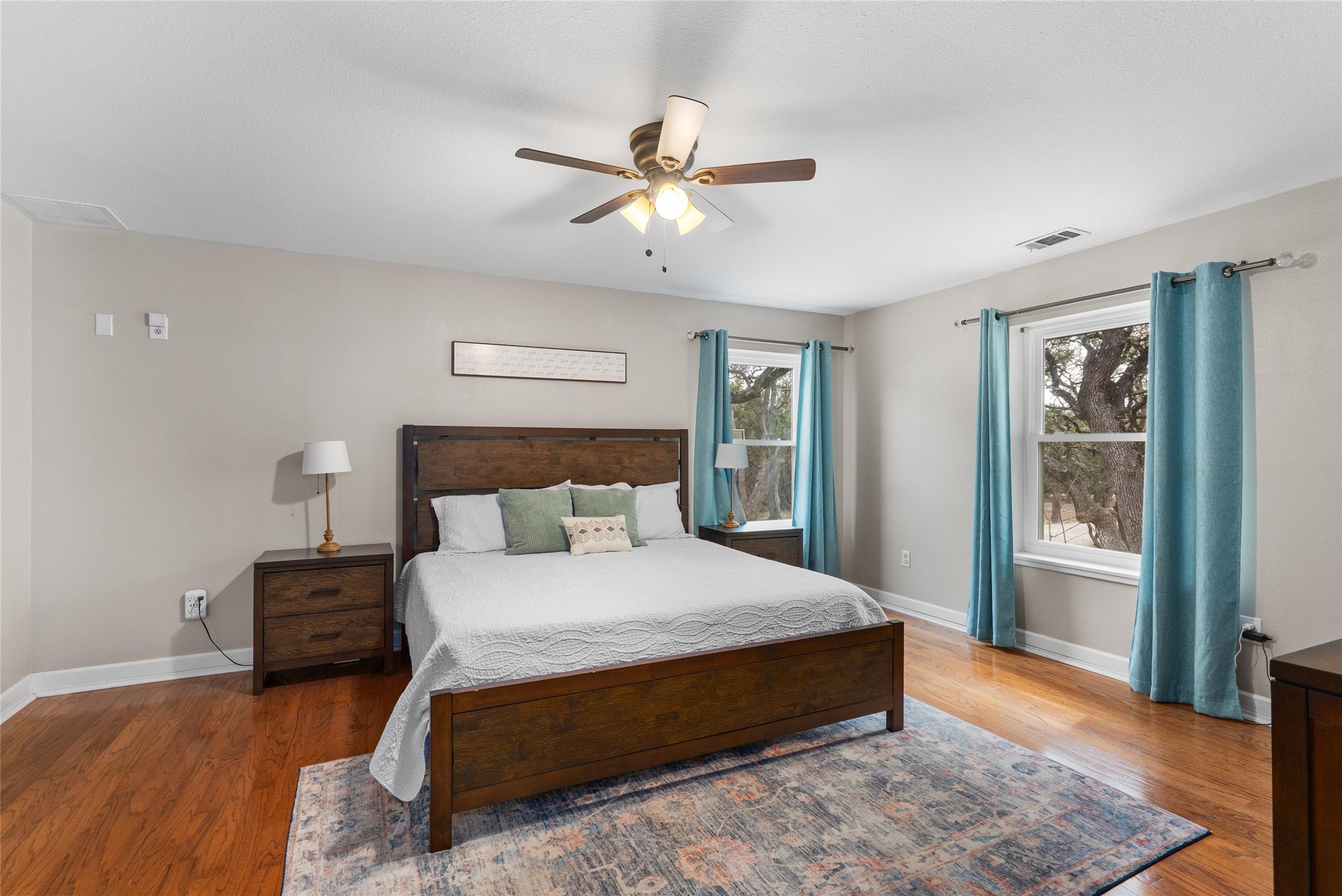 720 Circle G Ranch Road Austin, TX 78737 - Photo 20 of 37 a bedroom with a beds chandelier and a window