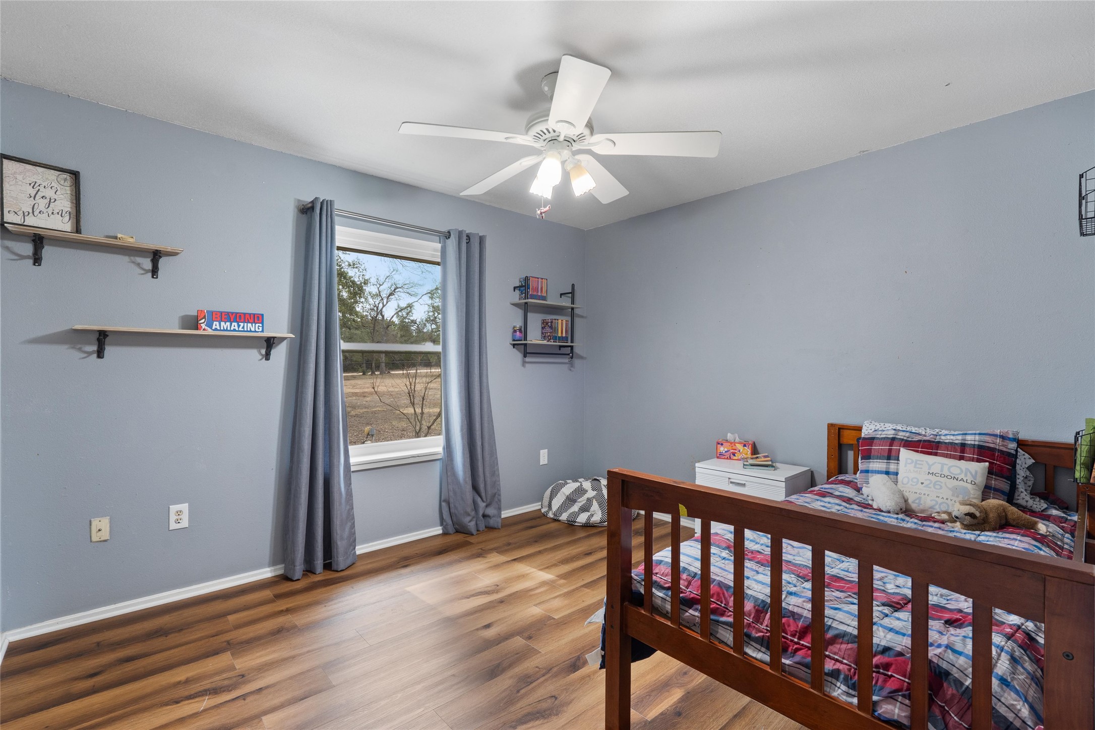 720 Circle G Ranch Road Austin, TX 78737 - Photo 23 of 37 a bedroom with furniture and a window