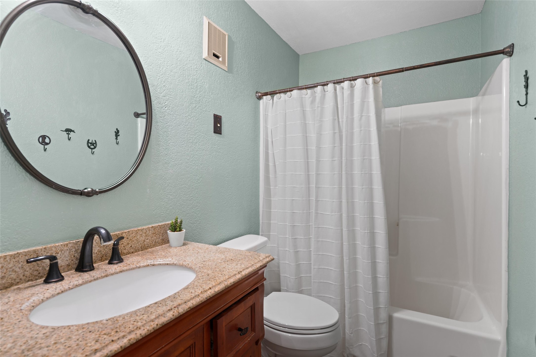 720 Circle G Ranch Road Austin, TX 78737 - Photo 25 of 37 a bathroom with a granite countertop sink and a mirror