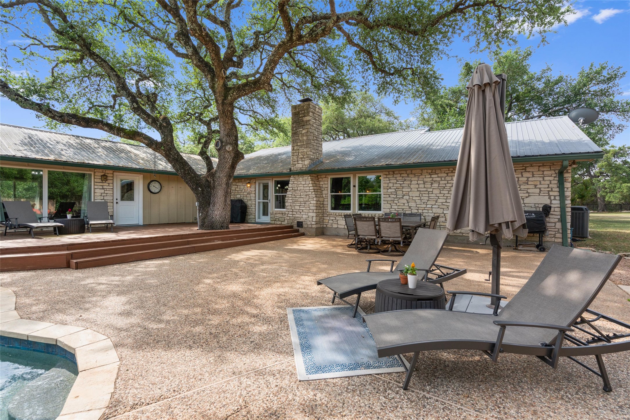 720 Circle G Ranch Road Austin, TX 78737 - Photo 29 of 37 a view of a house with backyard porch and sitting area
