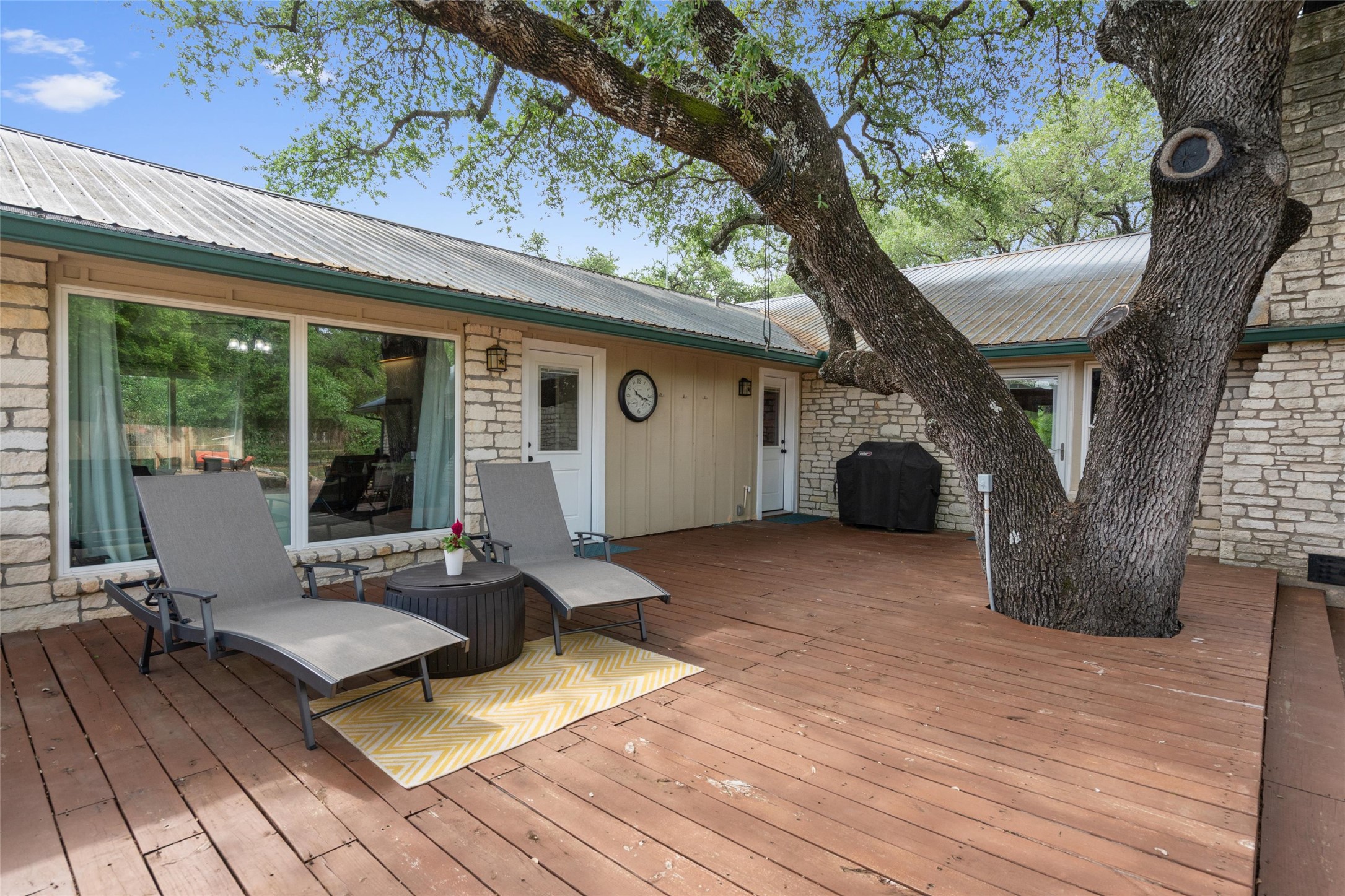 720 Circle G Ranch Road Austin, TX 78737 - Photo 30 of 37 a view of a patio with table and chairs near a large tree