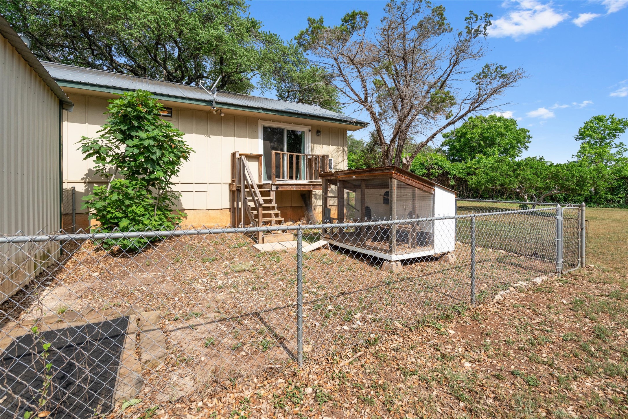 720 Circle G Ranch Road Austin, TX 78737 - Photo 32 of 37 a view of a house with backyard and a tree