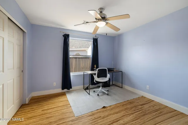 a workspace with wooden floor and a window