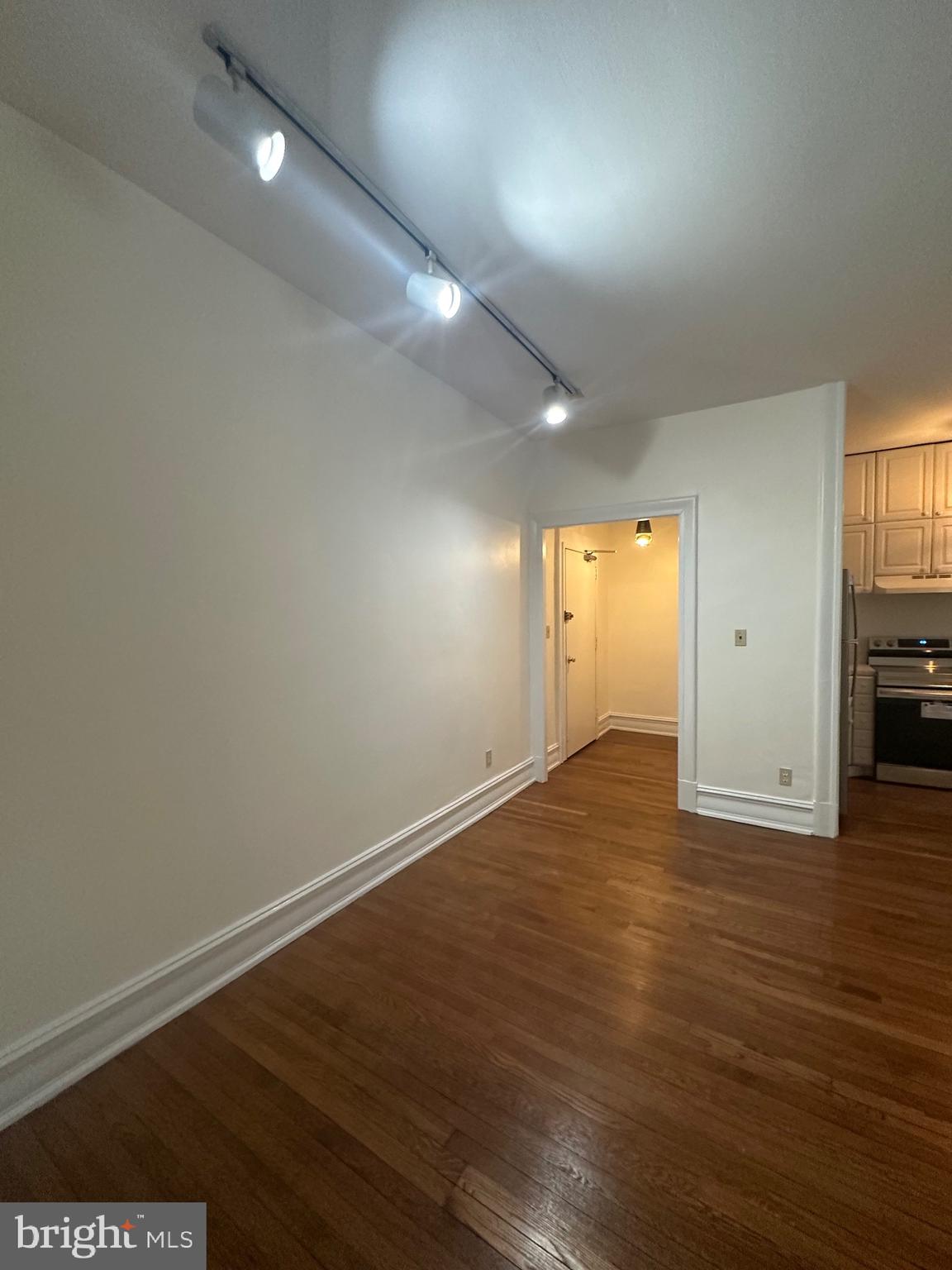 3420 16th Street Northwest, Unit 103 Washington, DC 20010 - Photo 11 of 24 an empty room with wooden floor and windows