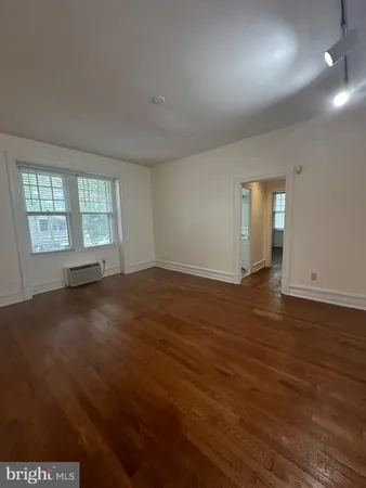 a kitchen with stainless steel appliances a refrigerator a sink a stove and white cabinets