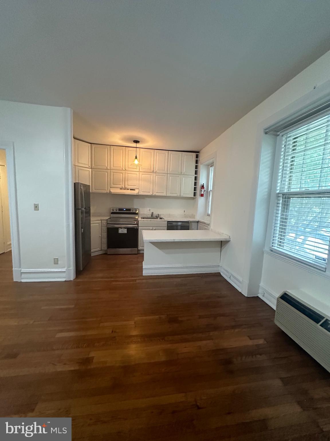3420 16th Street Northwest, Unit 103 Washington, DC 20010 - Photo 15 of 24 a kitchen with kitchen island a sink appliances and cabinets