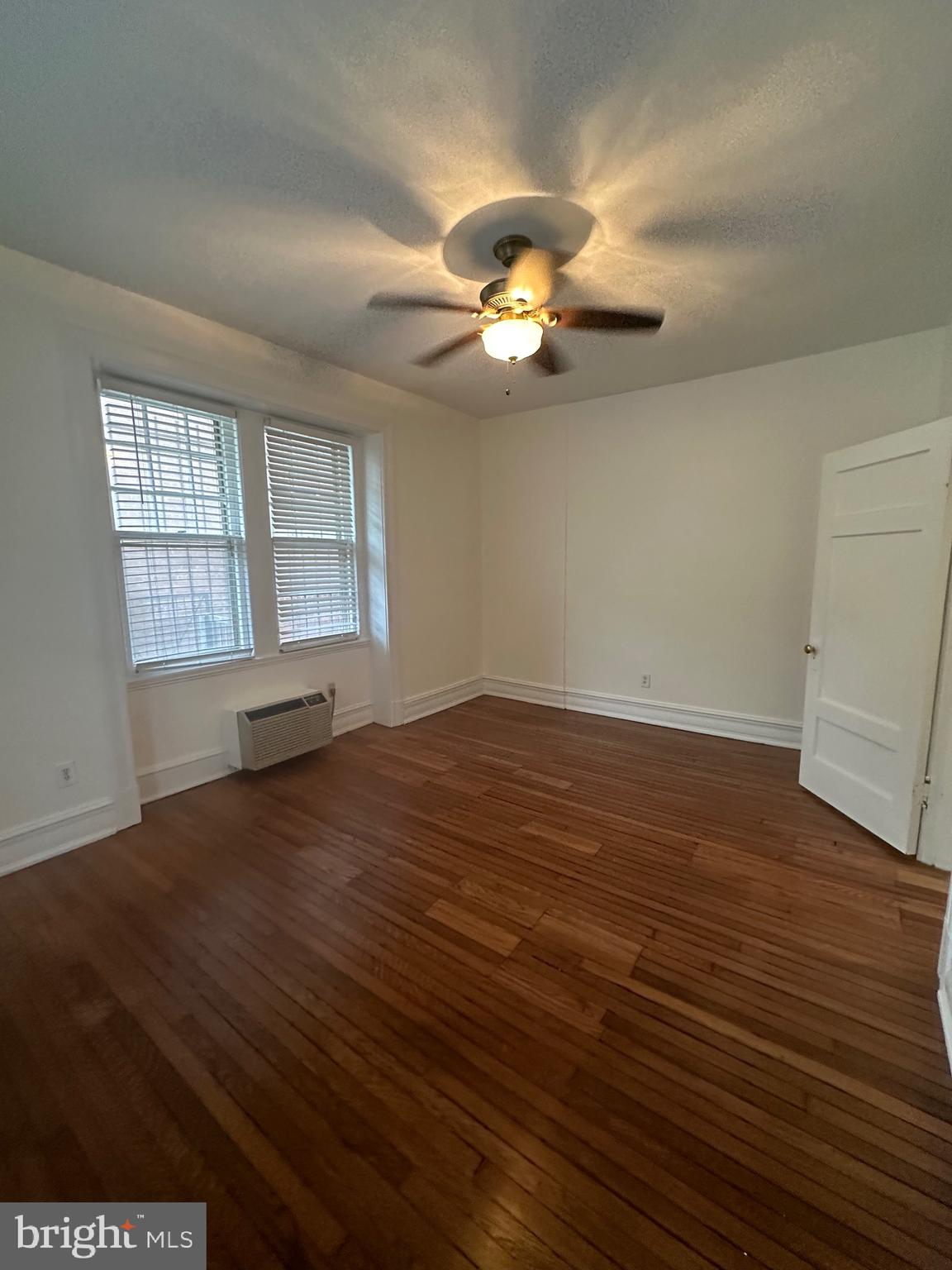 3420 16th Street Northwest, Unit 103 Washington, DC 20010 - Photo 21 of 24 an empty room with wooden floor and windows