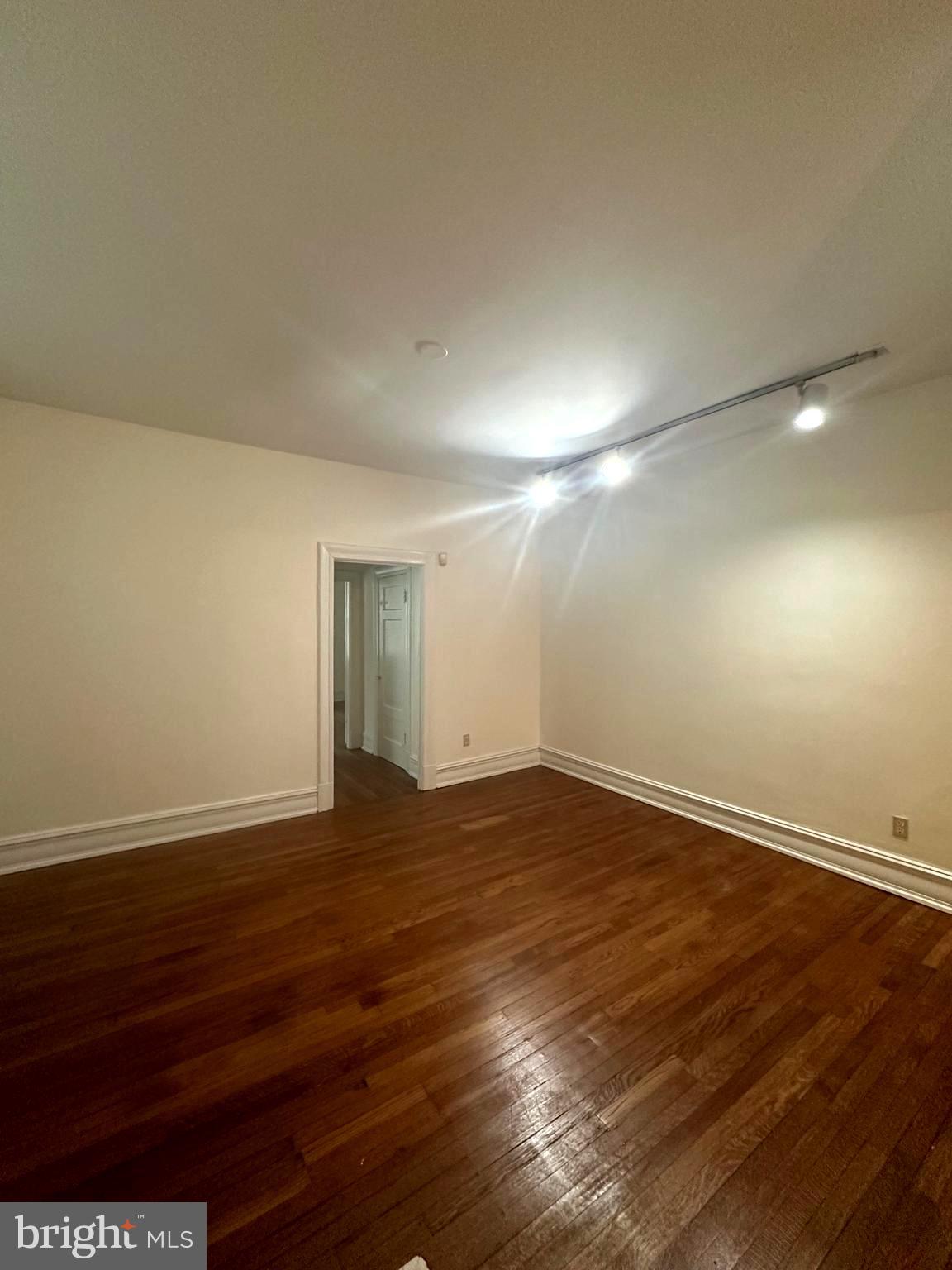3420 16th Street Northwest, Unit 103 Washington, DC 20010 - Photo 8 of 24 a view of an empty room with wooden floor