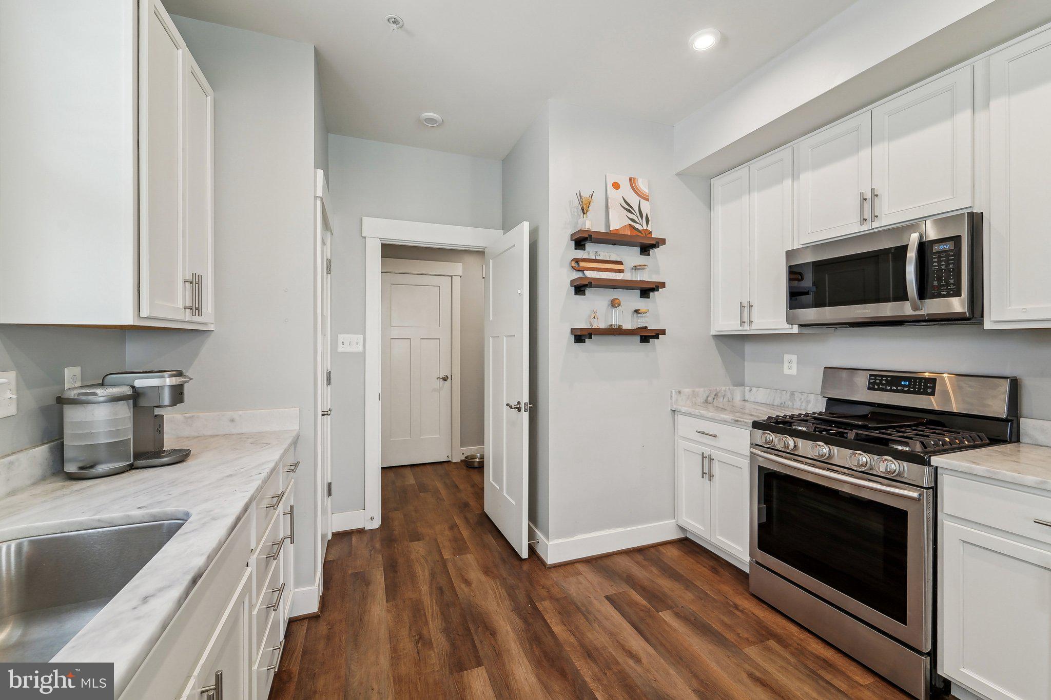 531 Highmeadow Drive Severn, MD 21144 - Photo 13 of 37 a kitchen with stainless steel appliances a stove microwave and sink