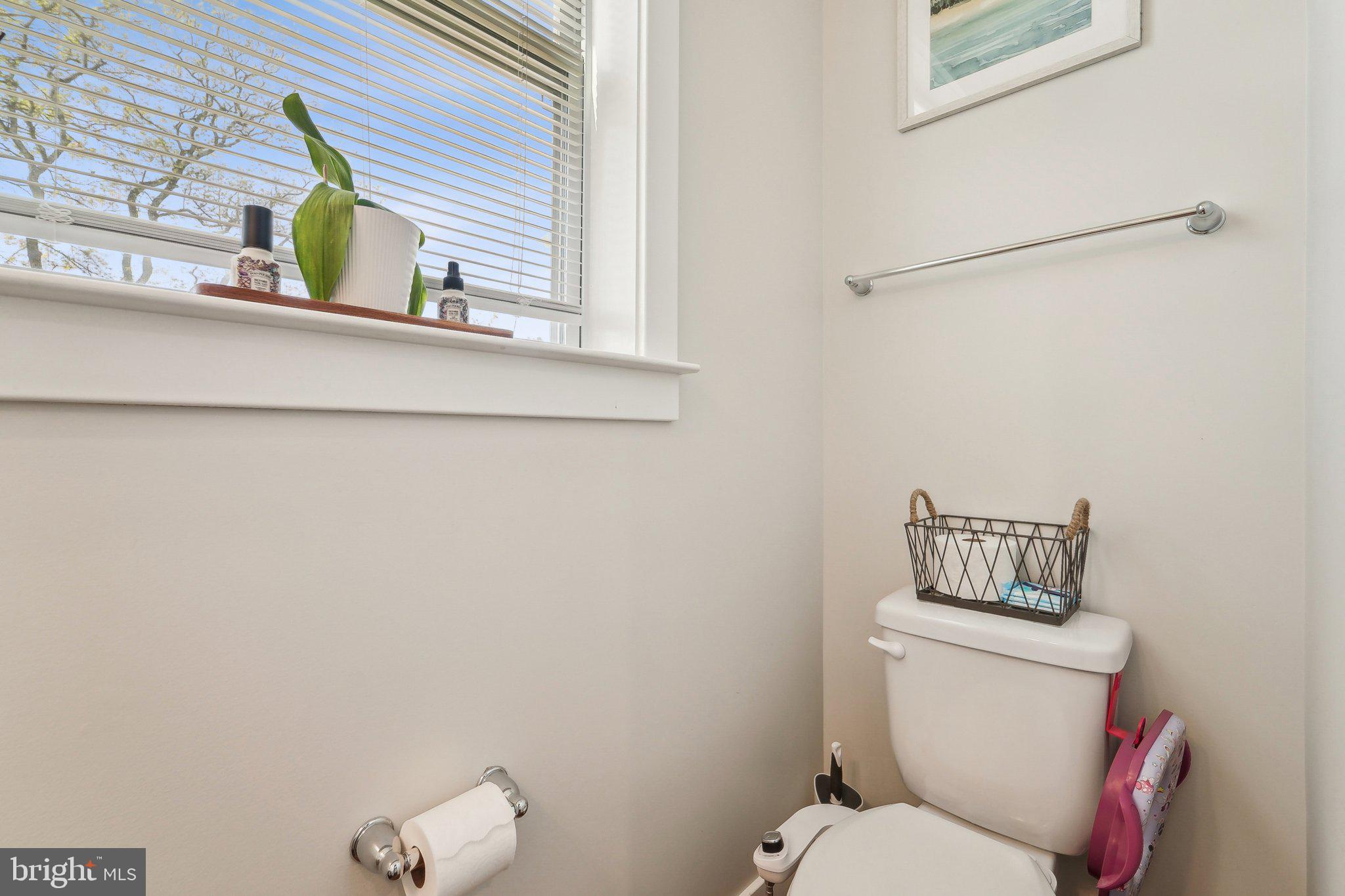 531 Highmeadow Drive Severn, MD 21144 - Photo 16 of 37 a bathroom with a toilet sink and mirror