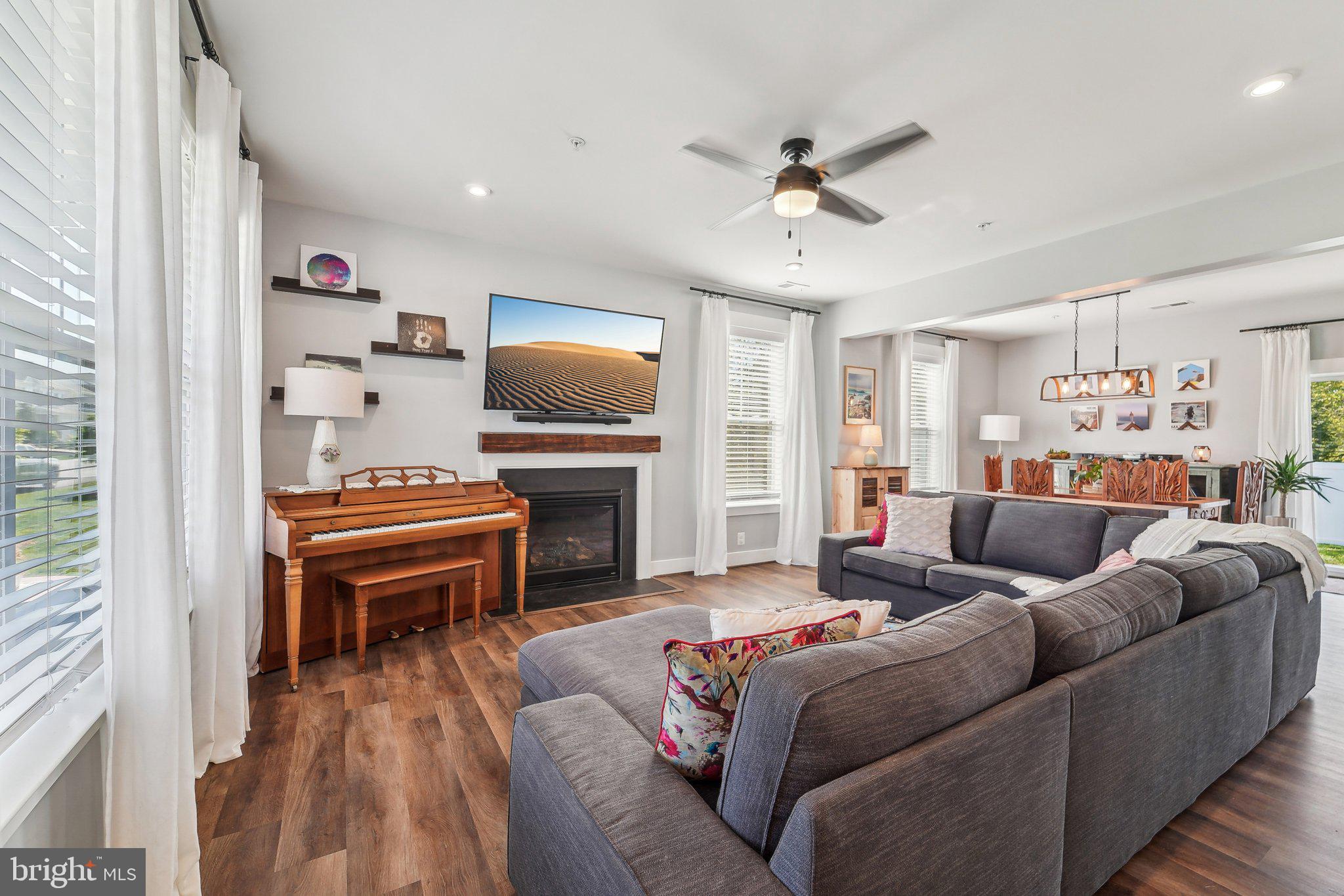 531 Highmeadow Drive Severn, MD 21144 - Photo 8 of 37 a living room with furniture and a piano next to a window