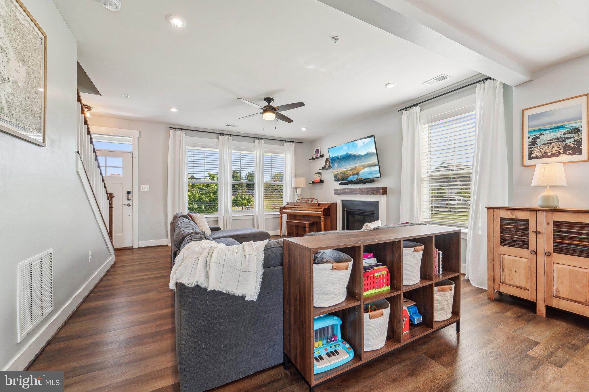 531 Highmeadow Drive Severn, MD 21144 - Photo 9 of 37 a living room with furniture a flat screen tv and a fireplace