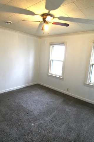 en empty room with windows and entrance