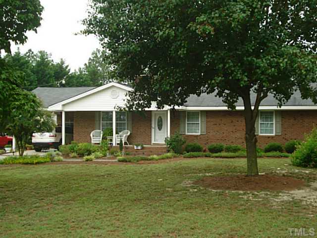 3595 Johnston County Road Angier, NC 27501 - Photo 1 of 18 a front view of a house with a yard and trees
