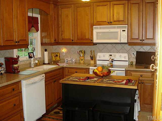 3595 Johnston County Road Angier, NC 27501 - Photo 11 of 18 a kitchen with a sink cabinets and appliances
