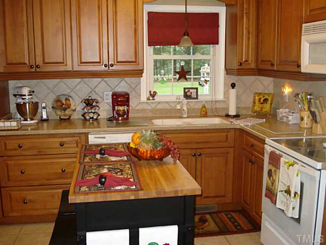 3595 Johnston County Road Angier, NC 27501 - Photo 12 of 18 a kitchen with stainless steel appliances granite countertop a stove a sink and a microwave