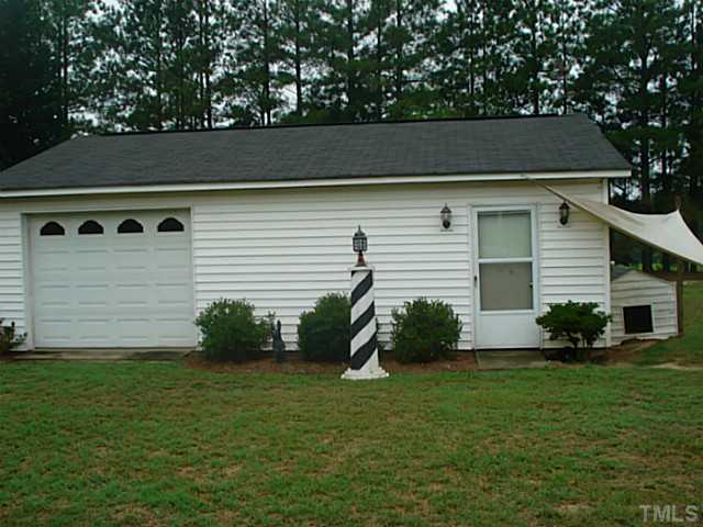 3595 Johnston County Road Angier, NC 27501 - Photo 16 of 18 a front view of a house with a garden
