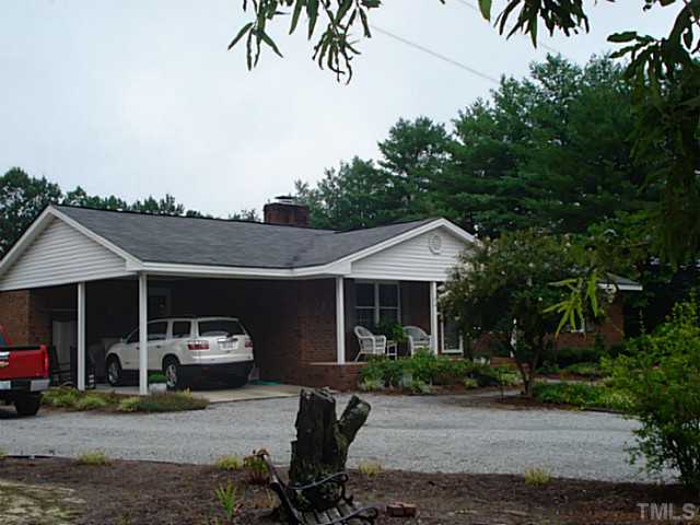 3595 Johnston County Road Angier, NC 27501 - Photo 2 of 18 a front view of a house with garden