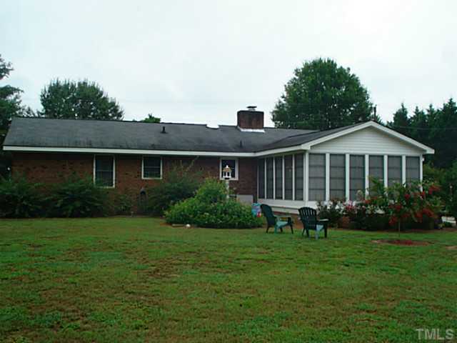 3595 Johnston County Road Angier, NC 27501 - Photo 3 of 18 a front view of a house with a garden and porch