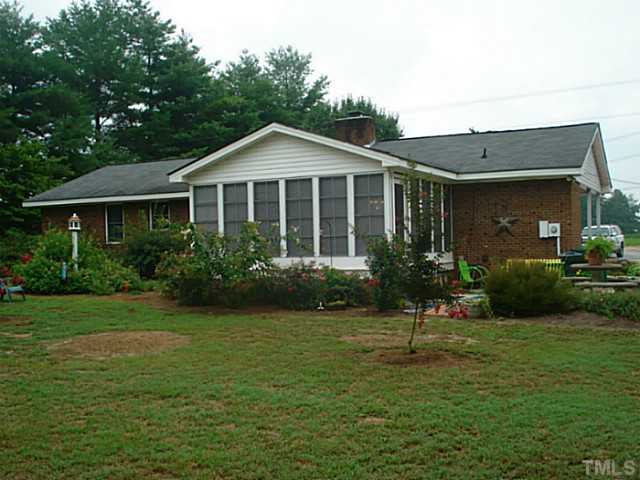 3595 Johnston County Road Angier, NC 27501 - Photo 4 of 18 a front view of a house with a yard