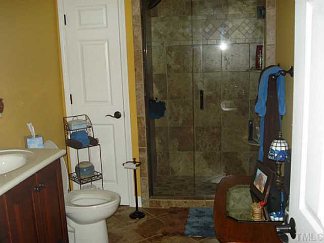 3595 Johnston County Road Angier, NC 27501 - Photo 6 of 18 a bathroom with a sink a toilet and shower
