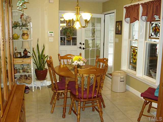 3595 Johnston County Road Angier, NC 27501 - Photo 10 of 18 a dining room with furniture a chandelier and wooden floor