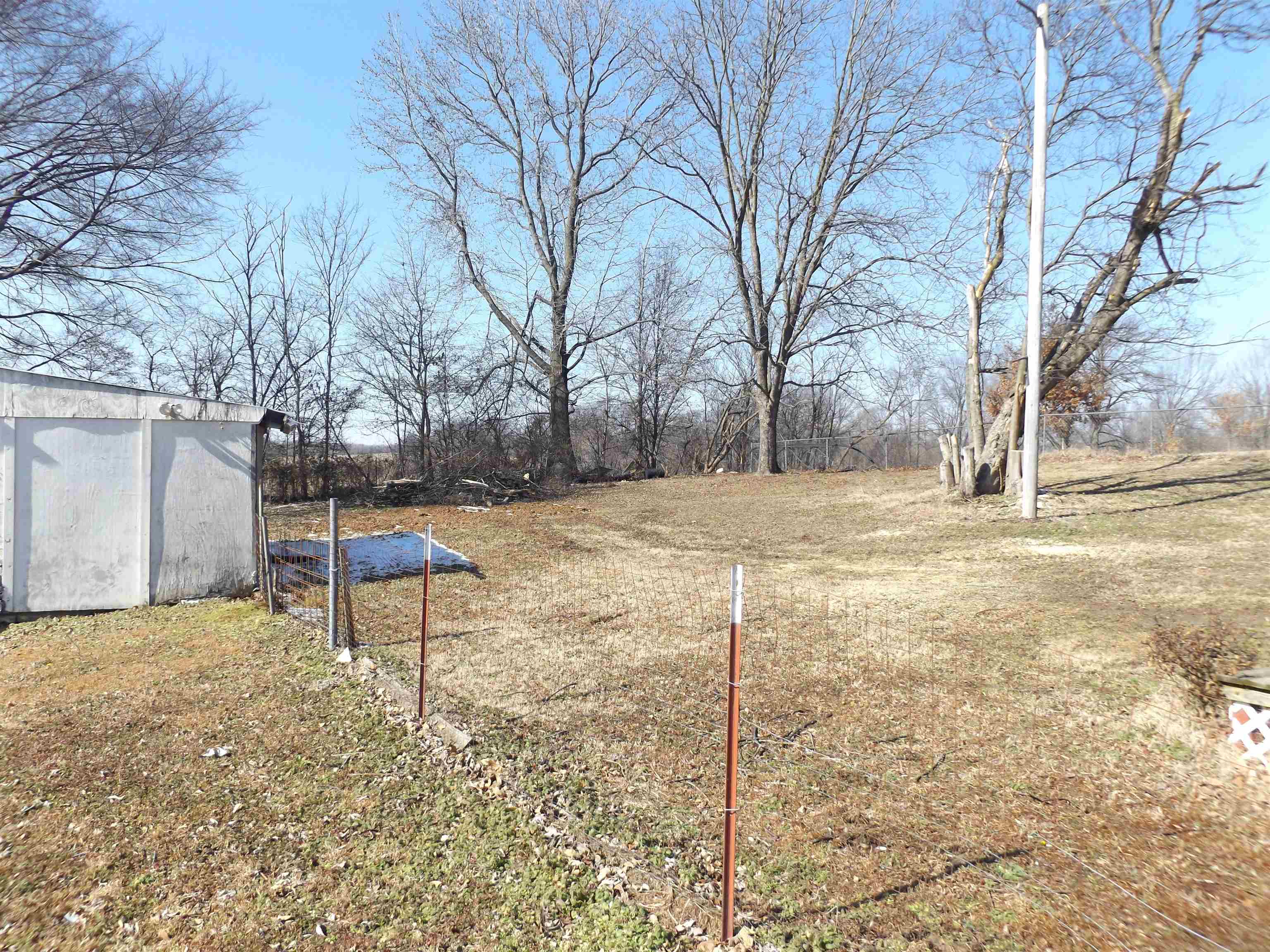5580 Lightfoot Luckett Road Ripley, TN 38063 - Photo 16 of 16 a backyard of a house with a bench and trees