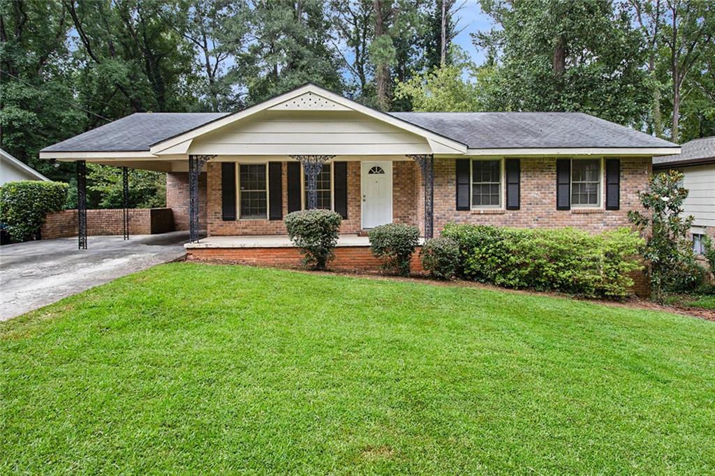 3684 Glen Mora Drive Decatur, GA 30032 - Photo 1 of 1 a patio with a table and chairs under an umbrella