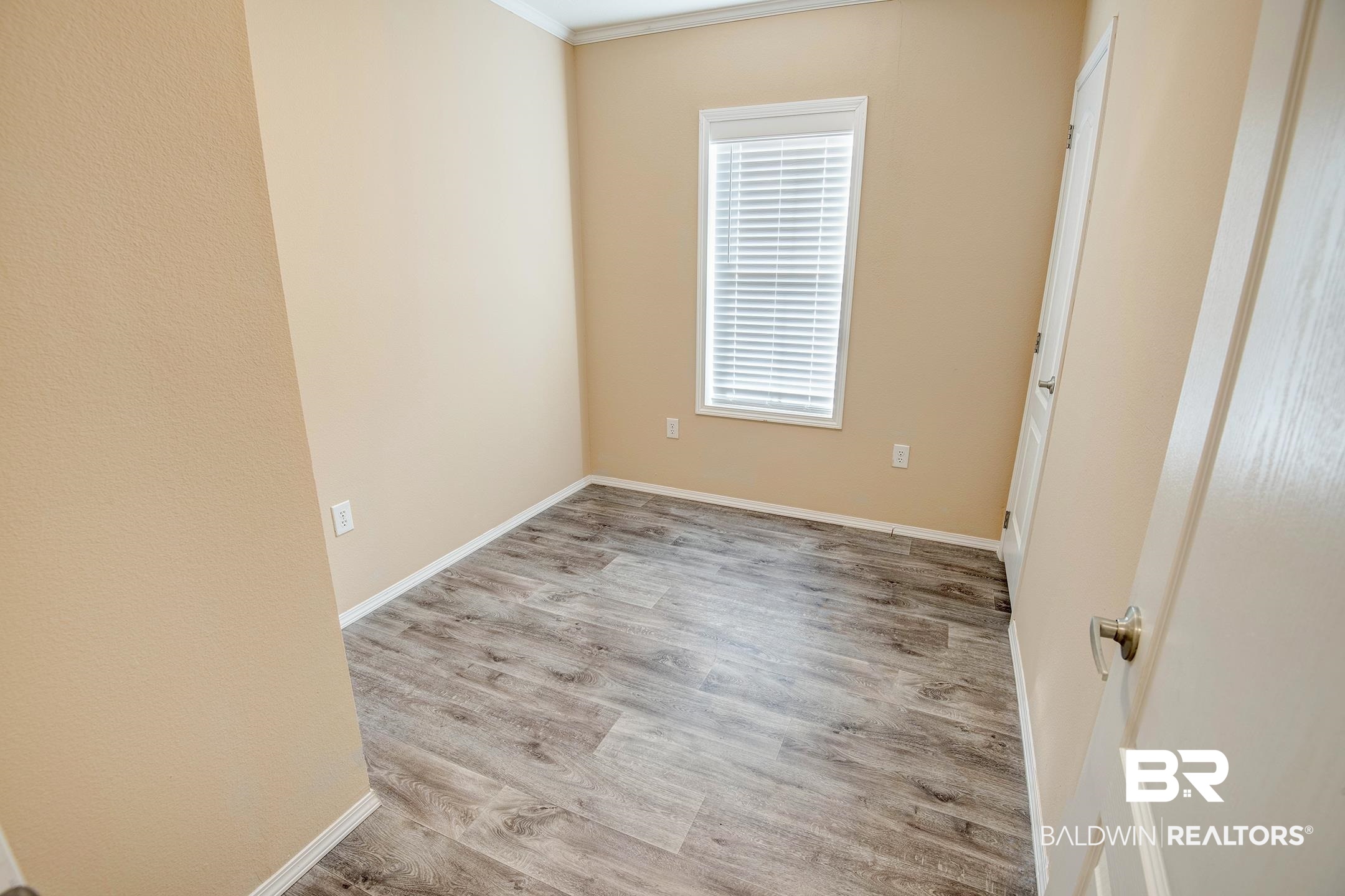 21859 West Side Loop Silverhill, AL 36576 - Photo 10 of 24 Empty room with light wood-type flooring and crown molding