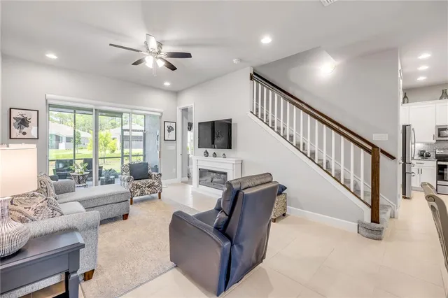 a kitchen with granite countertop white cabinets white stainless steel appliances and a sink